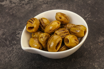 Green grilled olives in the bowl