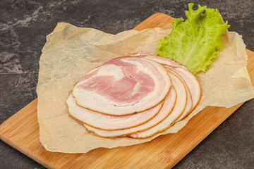 Sliced Pancetta sausage over board