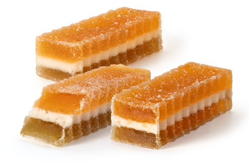 Three marmalade fruit candies on white background