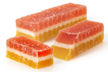 Three marmalade fruit candies on white background