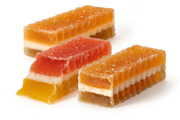Three marmalade fruit candies on white background