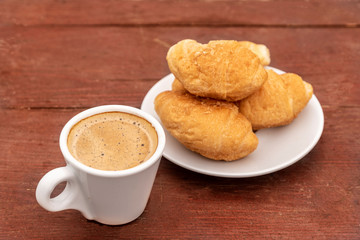 Croissants and espresso on wooden table