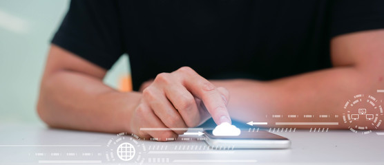 close up man hand touch screen on smart phone to transfer or synch data upload with laptop and download from cloud computing storage technology service with virtual interface for futuristic technology