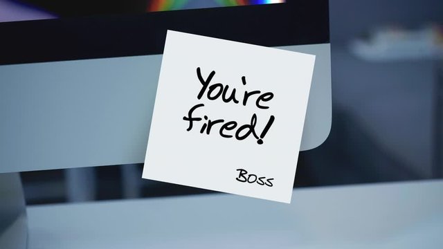 Sticky notes. You're fired. The inscription on the sticker on the monitor. Financial crisis, business crash. Dismissal during quarantine. Unemployment. Message. A message for an employee.	
