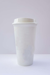 Paper cups with caps on grey background. Mock up.