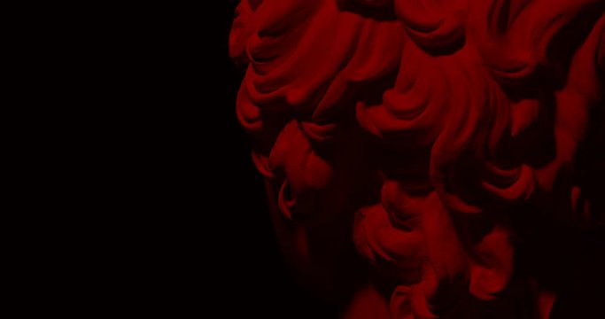 Epic studio close up detail shot of rotating gypsum head with moving and changing  red lighting. With free copy space for inscription or infografics. On black background isolated 4k