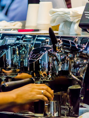 Espresso Machine pouring fresh coffee into cups at Local Coffee Shop..