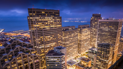 San Francisco Financial District buildings lit up at night.