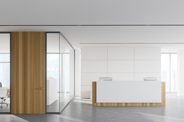 Reception in white office with wooden door
