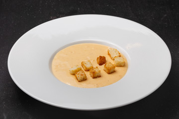 Soup in a plate for lunch in a restaurant