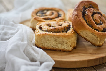 Tasty buns with raisins on a brown rustic wooden table. fresh bakery. breakfast. bread. top view