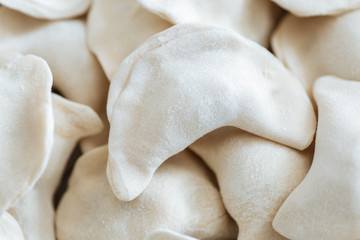 Fototapeta na wymiar Raw dumplings from the dough in handmade flour.Close up