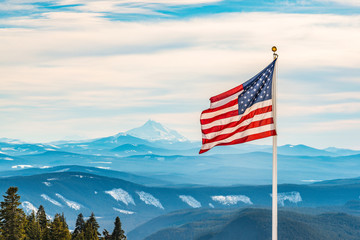 Fototapeta American flag over the peak of snow mountain obraz