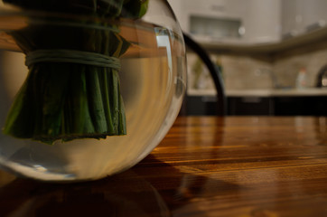 live lilies of the valley in a vase with water