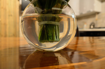 live lilies of the valley in a vase with water