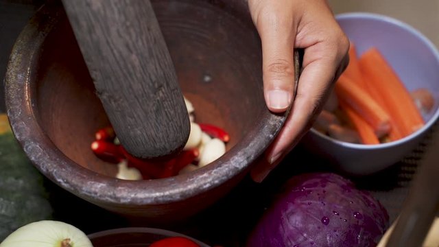 Slow Motion Clips,The chef is cooking the chili and garlic in a mortar.