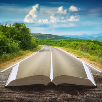 Asphalt road through the mountain valley on a book