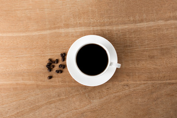 black coffee in a coffee cup top view isolated on wood background. with clipping path.