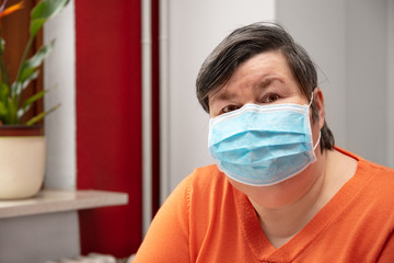 Mentally disabled woman wearing a surgical mask, covid-19 or corona
