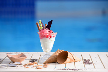 Panorama of glass with vanilla, watermelon ice cream on blur bokeh background with copy space....