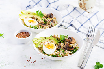 Breakfast oatmeal porridge with green herbs of mushrooms, boiled egg, avocado and flax seeds. Healthy balanced food.