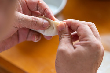 A chef is making dumplings