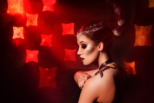 Beauty portrait of a girl with a live scorpion. Studio photography of a fashion portrait.