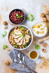 close-up view of tasty healthy couscous salat with figs fruits, nuts and pomegranate seeds
