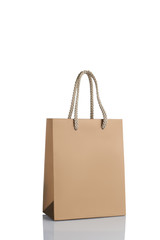 gold paper shopping bag isolated on white background. Mockup for design. sale concept.