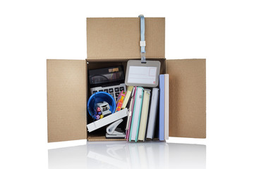 Dismissal. Box with office supplies. Cardboard box full of office stuff on white background