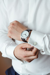 Men's style. Elegant young man getting ready. Shirt and cuffs. Successful businessman. Copy space for text. Close-up. 