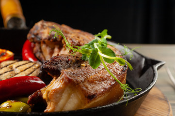Fried meat in a pan with vegetables bbq.
