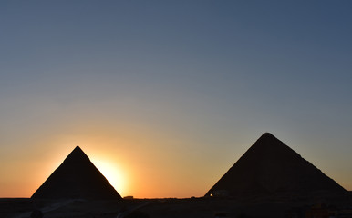 Fototapeta na wymiar beauty sunset background of pyramids giza CAIRO EGYPT.Silhouette pyramids when sunset and orange sky