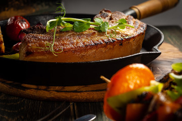 Fried meat in a pan with vegetables bbq.