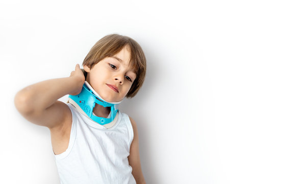 Child Complaining Of Neck Pain Wearing A Cervical Collar Support. White Background