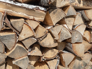 Birch firewood in a woodpile in a village