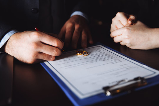 Merriage divorce process. Separation of spouses in the lawyer's cabinet. People sign agreement