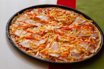 Raw pizza in a pan. Italian food cooking