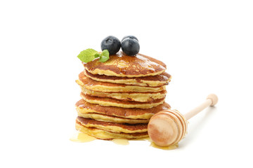 Tasty pancakes with honey and fruit isolated on white background