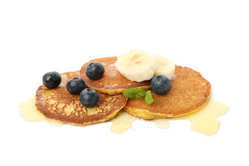 Tasty pancakes with honey and fruit isolated on white background