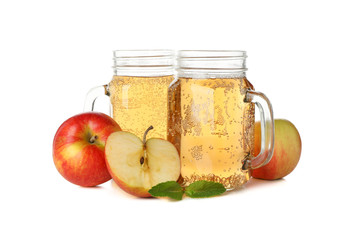 Apples and glass jars with cider isolated on white background