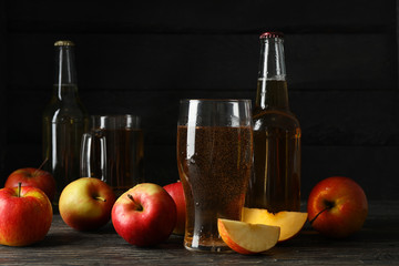 Composition with cider and apples on wooden background