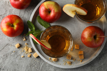 Composition with cider, sugar and apples on gray table