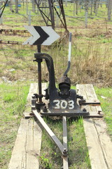 Railway arrow in black with a lever and pointer in Russia. The device for the transfer of rails at intersections for trains. Technical element of the railway industry.