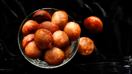 Homemade Kerala sweet snack, delicious Kerala snack unniyappam in dark background