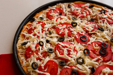 Raw pizza in a pan. Italian food cooking