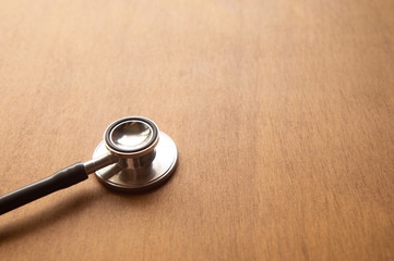 stethoscope on wood background.Flat lay with copy space.