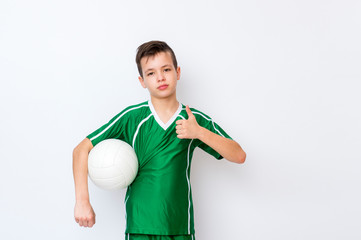 Kid in a green shirt with a ball for volleyball. Online workout concept