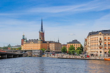center of the Scandinavian capital of Stockholm with smooth bay water, promenade, yachts and houses. Scandinavian architecture of cities.