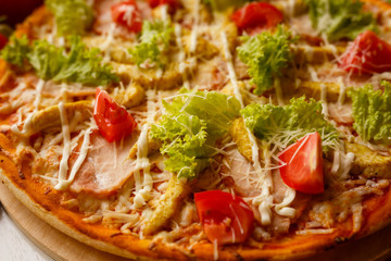 Hot italian pizza on a table with vegetables